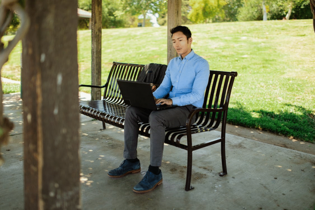 Man Using a Laptop in a Park